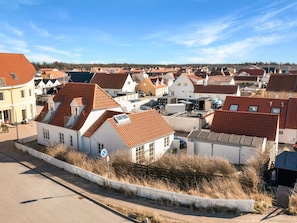 A residential area with houses featuring red-tiled roofs and white walls. - 5 Star Holiday Home in Lokken (Lokken)