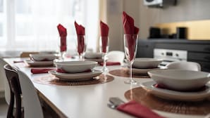 A dining table set with plates, glasses, and red napkins. - Stylish 3 Bd 3 Bath Duplex In Brussels (Brussels)