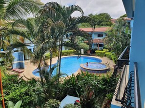 Relax by the pool surrounded by lush tropical vegetation and beautifully maintained gardens.