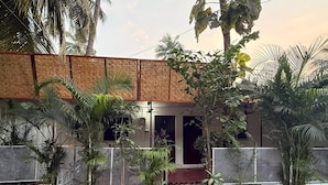 A house with a paved entrance, surrounded by a fence and various potted plants. - The Village Harmony by Red Rose (Canacona)