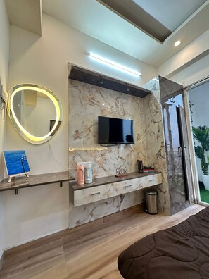Enjoy a relaxing space with a bathtub, flat-screen TV, and balcony access.