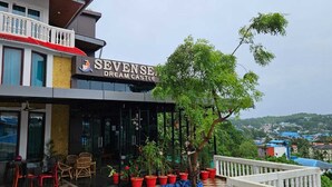 A hotel named "SEVENSE Dream Castle" with outdoor seating and potted plants. - Seven Seas Dream Castle Port Blair (Port Blair)