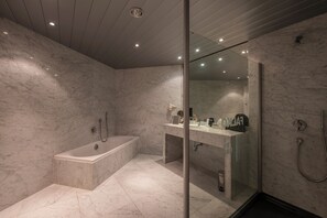 Premium tweepersoonskamer | Badkamer | Een bad/douchecombinatie, gratis toiletartikelen, een haardroger