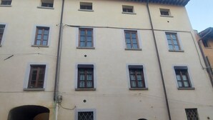 Un edificio de varios pisos con una serie de ventanas y una entrada principal.
