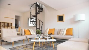 A modern living room with a spiral staircase, a sofa set, a coffee table, and a floor lamp. - Luxury Nassa Penthouse with Private Terrace in Lugano (Lugano)