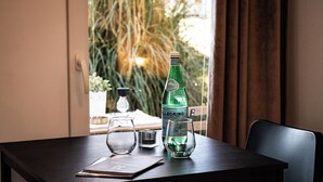 A table with a bottle of Pellegrino water, two glasses, and a menu. - Apartments & Rooms Buble - Studio with terrace (Trogir)