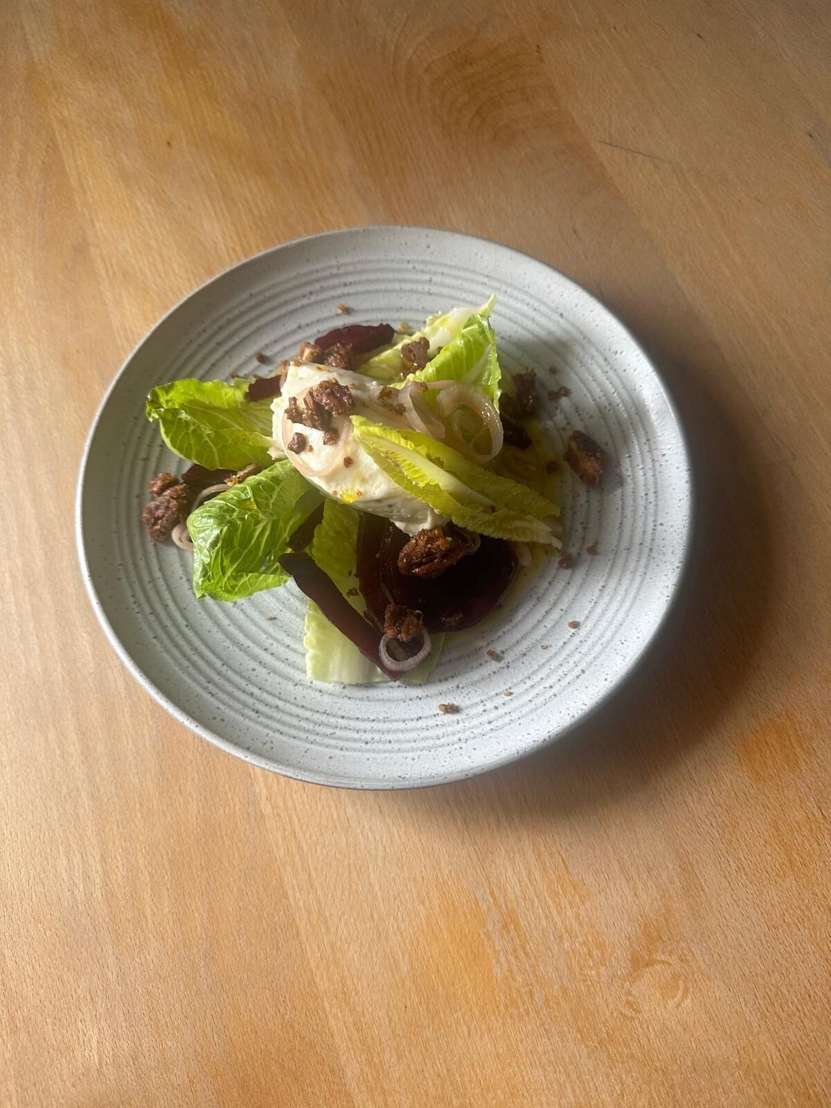 A plate of food on a wooden table.