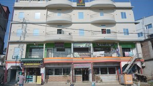 A multi-story building with a hotel named "Aaradhya Hotel" on the top floor. - Hotel Aaradhya (Guwahati)