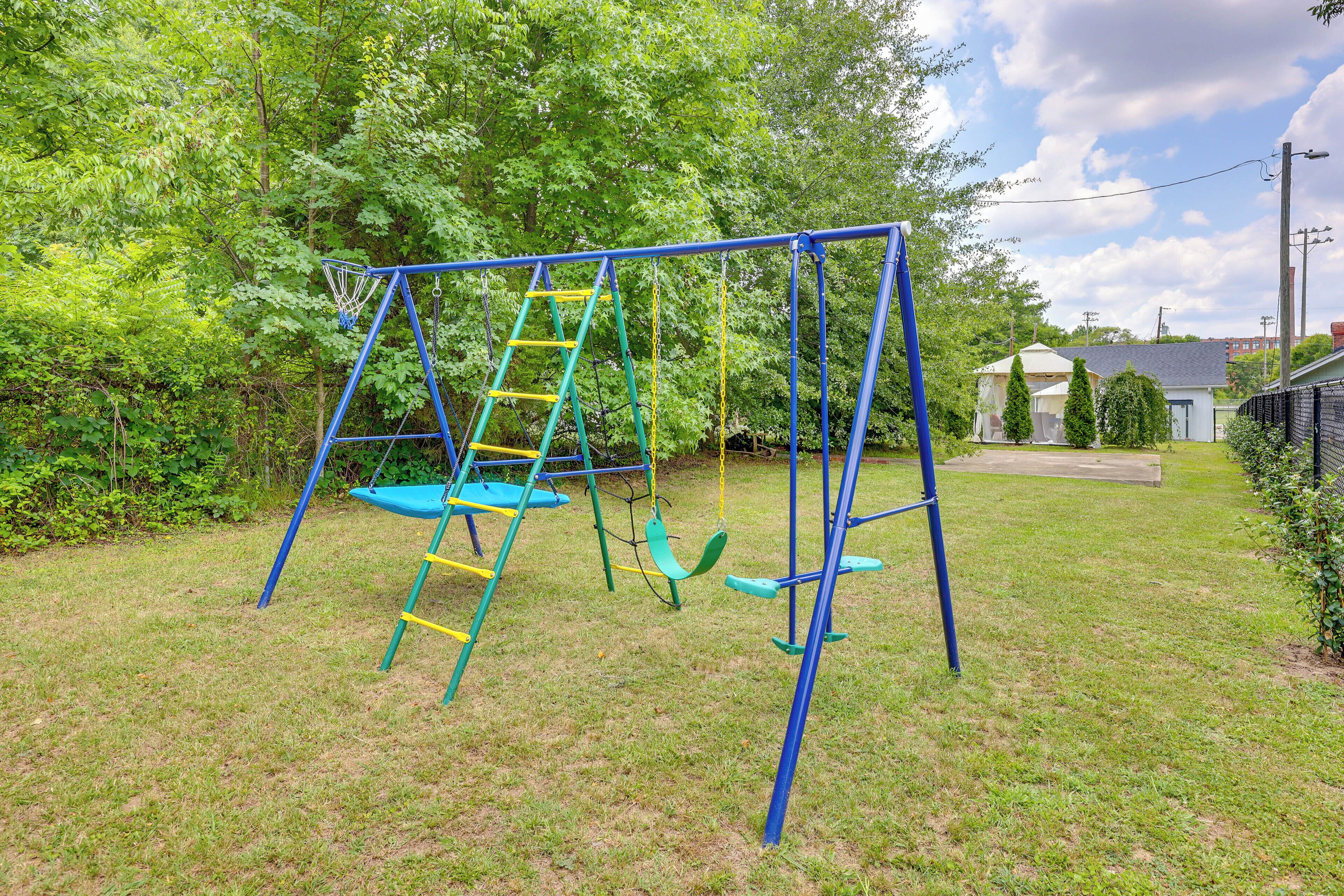 A playground with a swing set and a ladder.