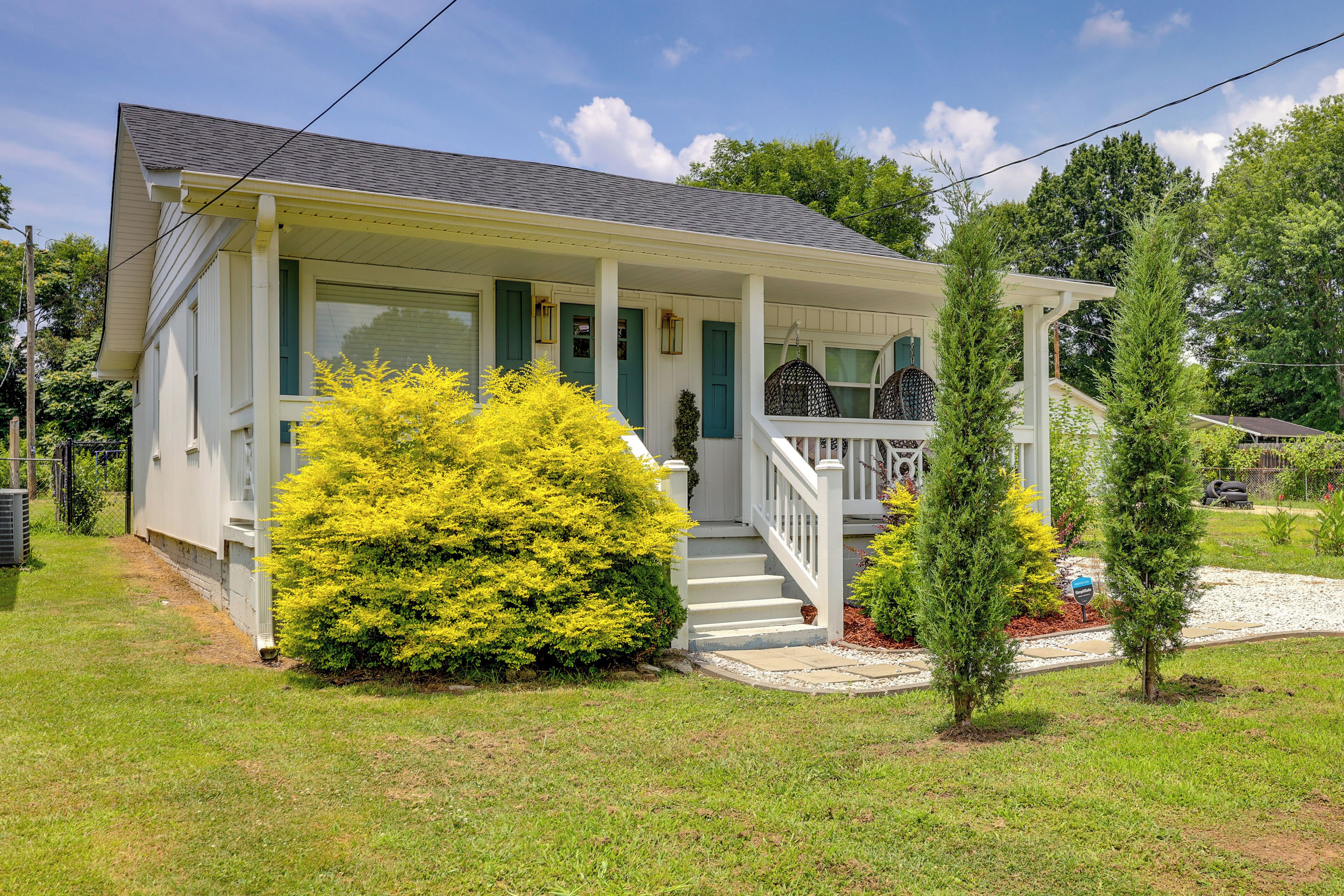 A single-story house with a porch, a small front yard, and a visible mailbox.