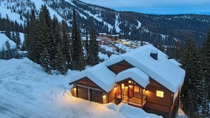 A log cabin with a snow-covered roof, surrounded by a mountainous landscape. - Stunning View! Peaceful & Modern Schweitzer Chalet (Sandpoint)