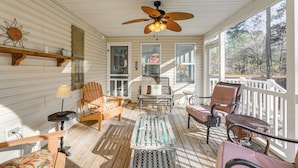 A covered porch with wooden flooring, a ceiling fan, and various seating options including chairs and a bench. - 8 Mi to Beach: Ocean Pines Home Near Marina & Golf (Berlin)