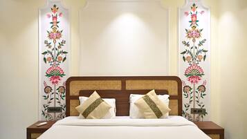A hotel room with a bed, two nightstands, and decorative wall panels.