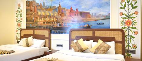 A hotel room with two beds, a mural of a cityscape, and decorative floral patterns on the walls.