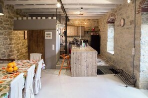 Cozy kitchen with central island, dining area, and natural light.
