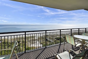 A balcony with a view of the ocean, equipped with metal chairs and a small table. - Southwind 802 5 Bedroom Condo (Myrtle Beach)