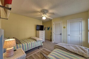 A bedroom with two single beds, a dresser, a ceiling fan, and a television on a stand. - Sea Cloisters 305e 2 Bedroom Condo (North Myrtle Beach)