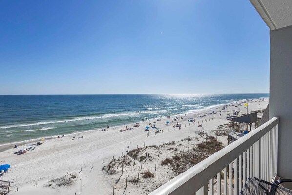 A beach with a clear view of the ocean and a balcony overlooking the beach. - Caribbean 502 1 Bedroom Condo (Gulf Shores)