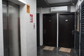 Corridors feature modern design with emergency exits and air conditioning.