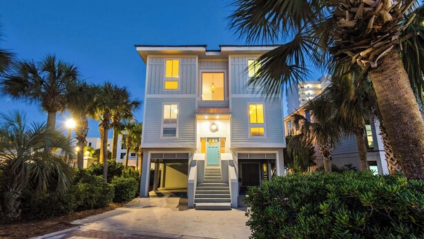 A two-story building with a central entrance, a staircase, and a light fixture above the door. - Luxurious gulf side living with Golf Cart! + Free Dolphin Cruise! (Santa Rosa Beach)