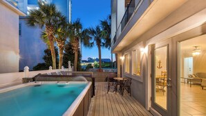 A rooftop pool area with a hot tub, wooden deck, and outdoor seating. - Luxurious gulf side living with Golf Cart! + Free Dolphin Cruise! (Santa Rosa Beach)