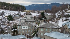 A historic town with stone buildings and a prominent green building with a metal roof.