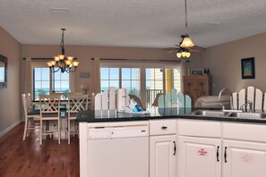 Enjoy cooking in this well-equipped kitchen with a central island, double sink, and ample counter space.