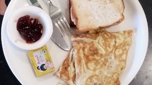 A plate with toast, a small bowl of jam, and a packet of butter. - Milestone Homestay Agra (Agra)