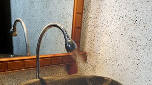 A stone sink with a faucet and a mirror above it. - Relax Villas Gili Air (Gili Air)