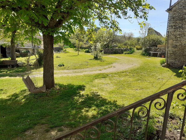 A stone building with a rustic charm, surrounded by a well-maintained grassy area and trees. - A quiet, relaxing "Ferme étoilée" in Ussac (Saint-Chels)