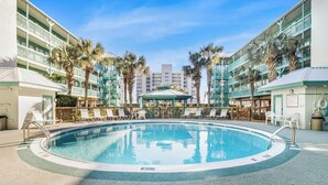 A pool area with lounge chairs, a gazebo, and palm trees. - 🌞Low Density | Community Pool | Sea Breeze 203🌞 (Gulf Shores)