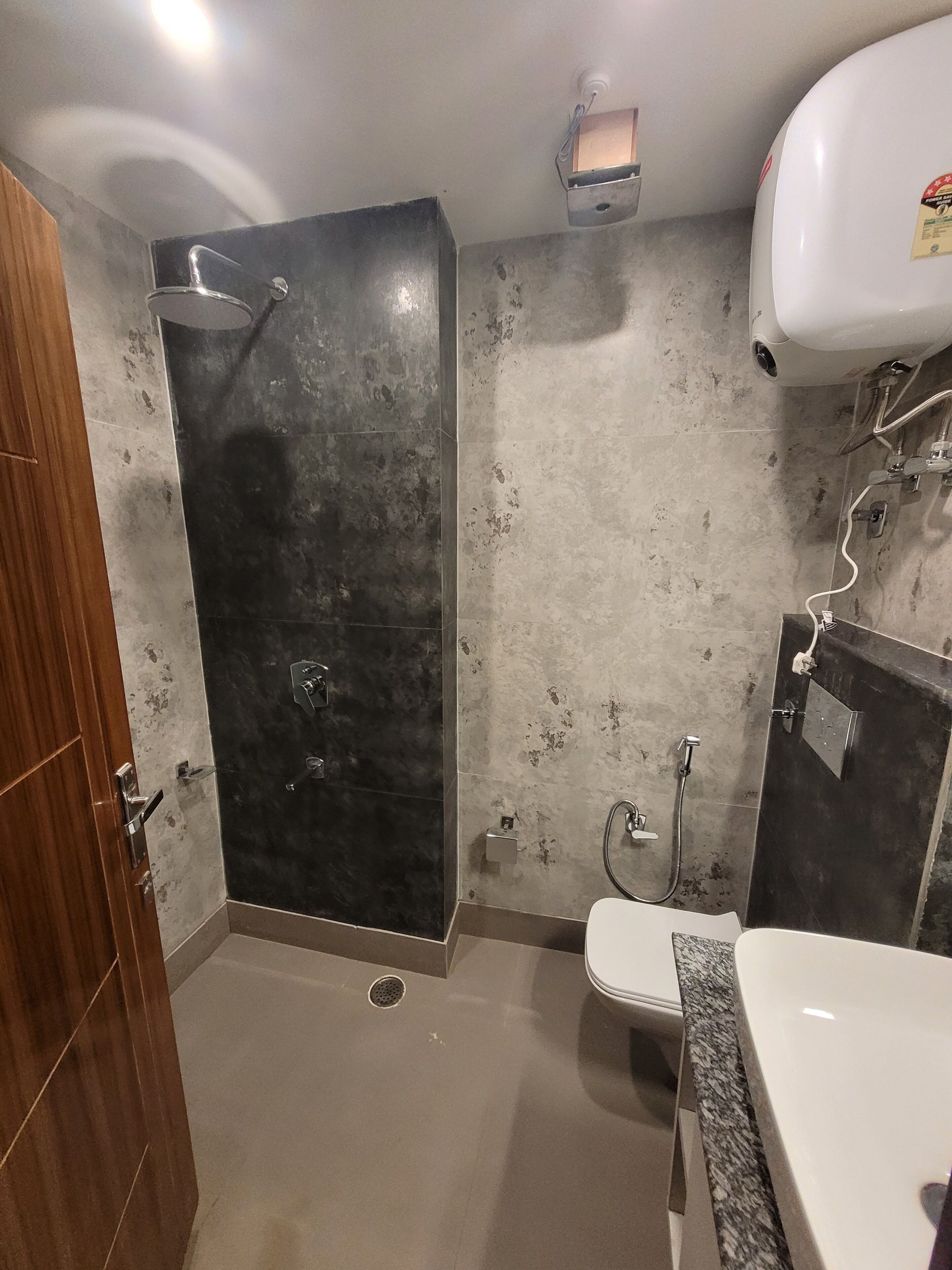 A bathroom with a shower, toilet, and sink.