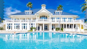A large, two-story building with a swimming pool in front. - Beach Club 210 - King/King/Queen/Sofa Sleeper - 2nd FL Corner by the Club- 8 max (Gulf Shores)
