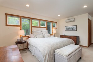 A bedroom with a large bed, two bedside tables, a nightstand, a wooden bench, and a dresser. - Relax & Recover Mountain Retreat - Hot Tub + Sauna + Home Gym (Winhall)