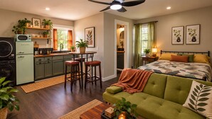 A compact living space with a kitchenette, a dining area, and a bedroom. - Cozy Starkville Cottage — 4 Peaceful Acres + Pet Friendly (Starkville)