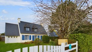 A house with a white fence, a blue door, and a mailbox with the number 51. - Large family home 10 minutes from the beach (Fouesnant)
