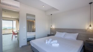 A modern hotel room with a large bed, a desk, and a view of the sea. - Sky-High 70sqm Penthouse w. Stunning Views - 05

 (Chania)