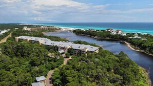 A resort with multiple buildings, a marina, and a view of the ocean.