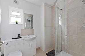 Shower, hair dryer, towels, shampoo