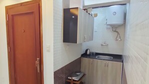 A modern kitchen with a built-in stove, a sink, and a water heater. - HS STIDUS 1 (Giza)