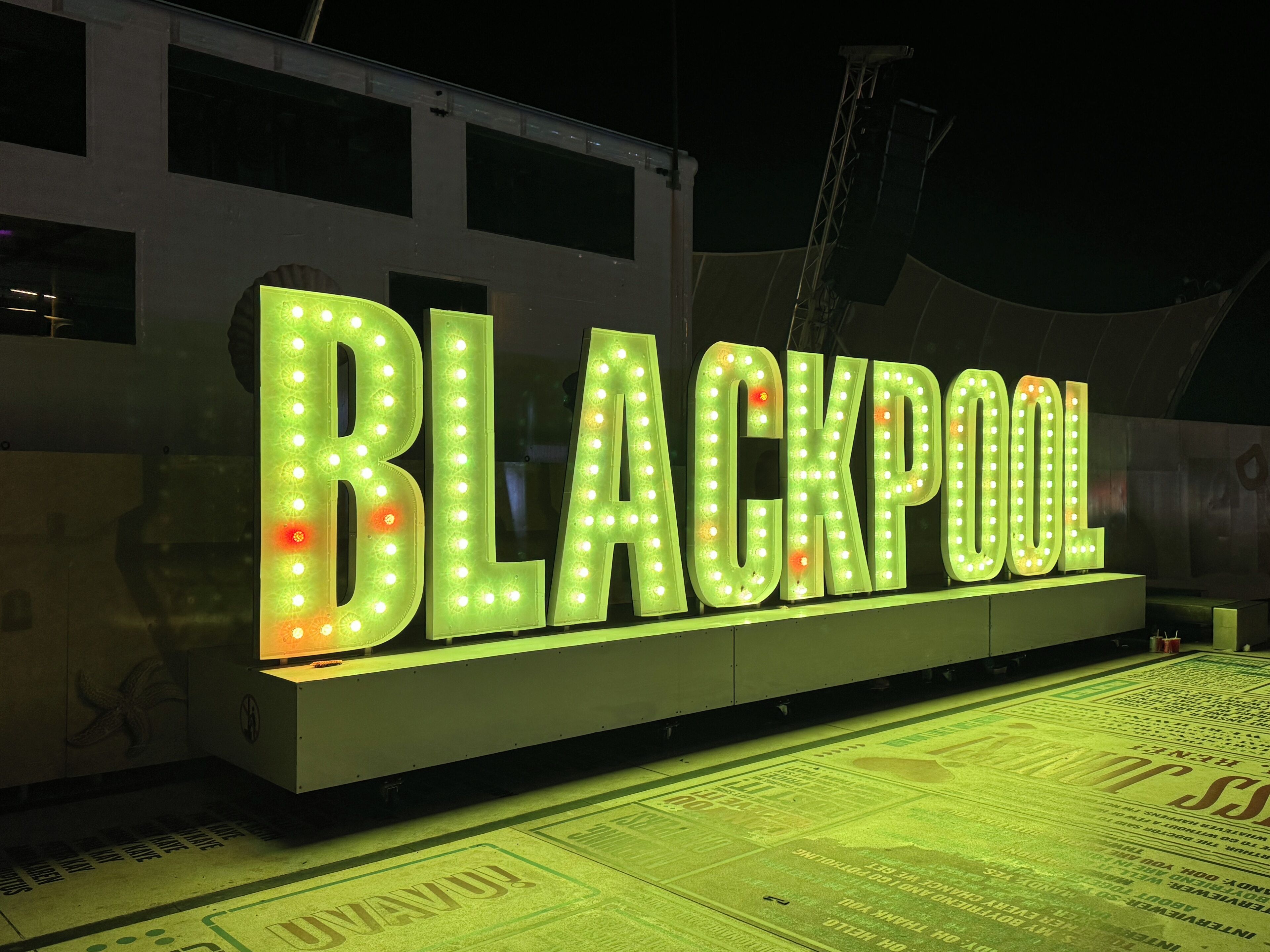 A large illuminated sign with the word "BLACKPOOL" in bold letters.