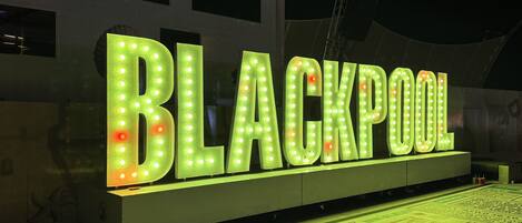 A large illuminated sign with the word "BLACKPOOL" in bold letters.