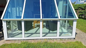 A modern house with a large glass extension featuring multiple windows and a white frame. - Bungalow for 6 People Near Beach (Sint Maartensvlotbrug)