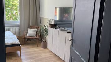 1 bedroom, desk, iron/ironing board, travel crib