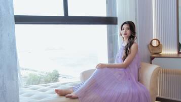 Guests can relax on the plush sofa by the window, taking in the view of the surrounding landscape.