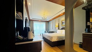 Una habitación de hotel con cama, mesita de noche y un espejo grande.