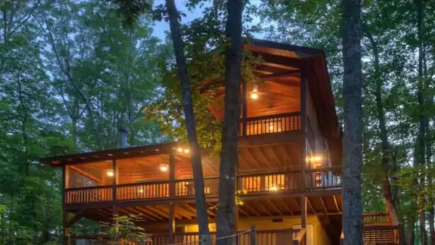 A multi-level wooden cabin with balconies, surrounded by trees. - Misty Lake Getaway - Hot Tub/Dog Friendly/EV Charger (Blue Ridge)