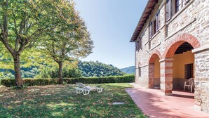 A stone building with a covered patio and a tree in the foreground. - 6 bedroom amazing home in Dicomano (Dicomano)