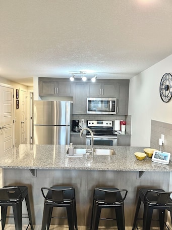 Private kitchen. Cozy 1-bedroom condo in amazing Calgary with WiFi