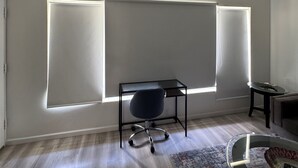 A modern room with a desk, chair, and a ceiling fan. - Location Lake Eola View 1 Bedroom condo (Orlando)